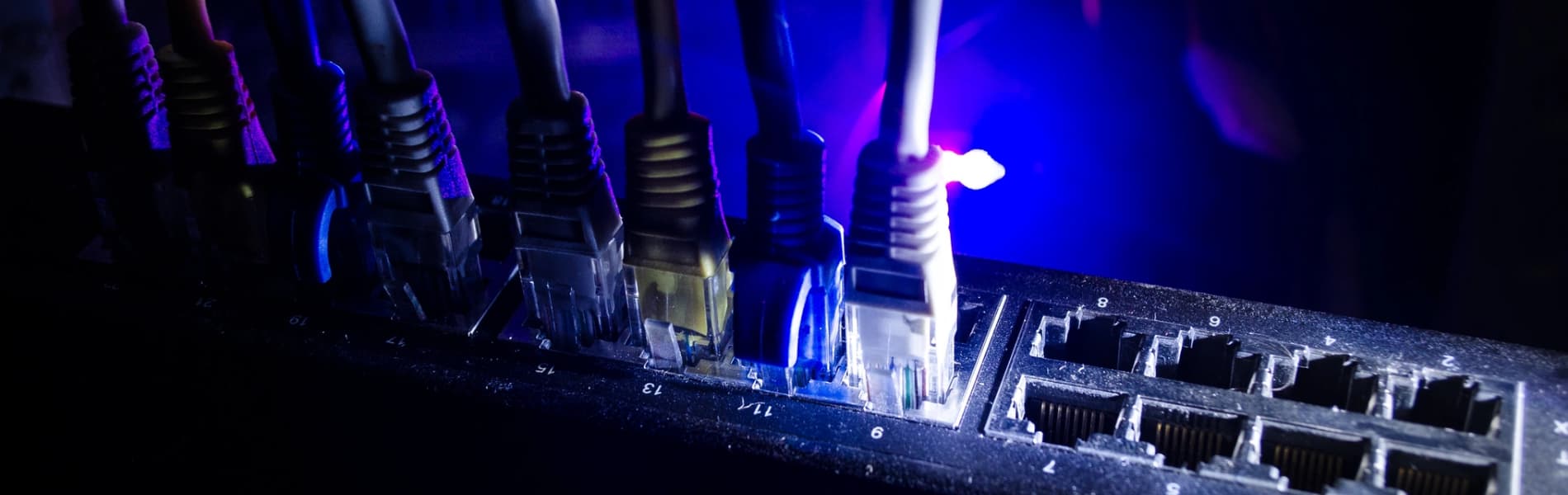 Technician working on an Ethernet patch panel in a Westchester County home