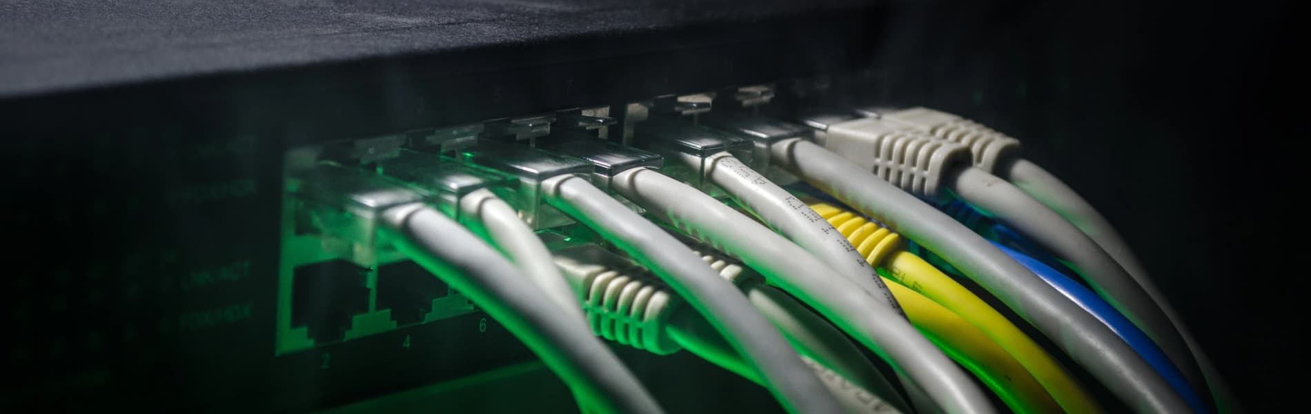 Technicians working on a network rack during a cabling project in Westchester County