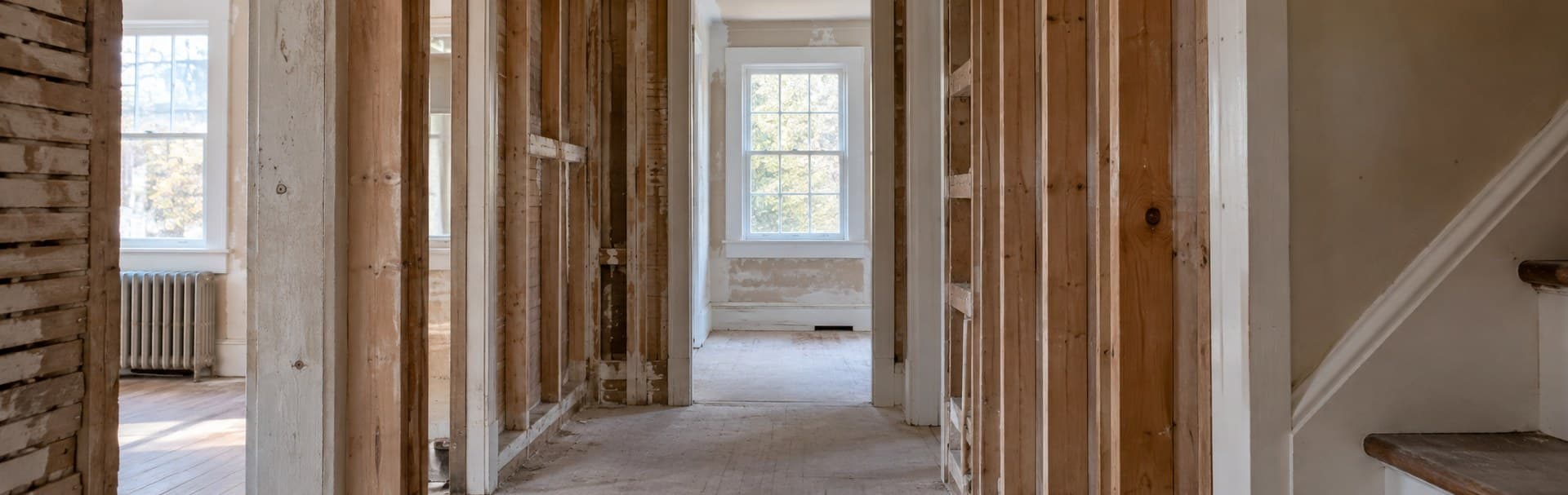 Home corridor with open wall framing during a renovation, before network cabling is planned