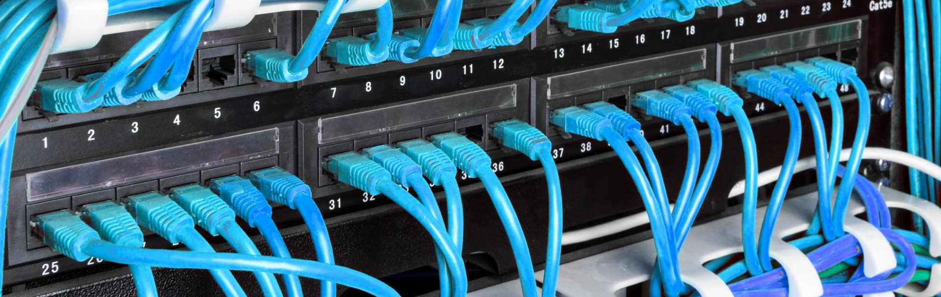 Choosing a network cabling company — technician labeling a rack in Westchester
