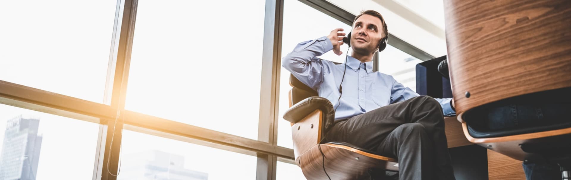 Professional using a business communications headset in a modern office