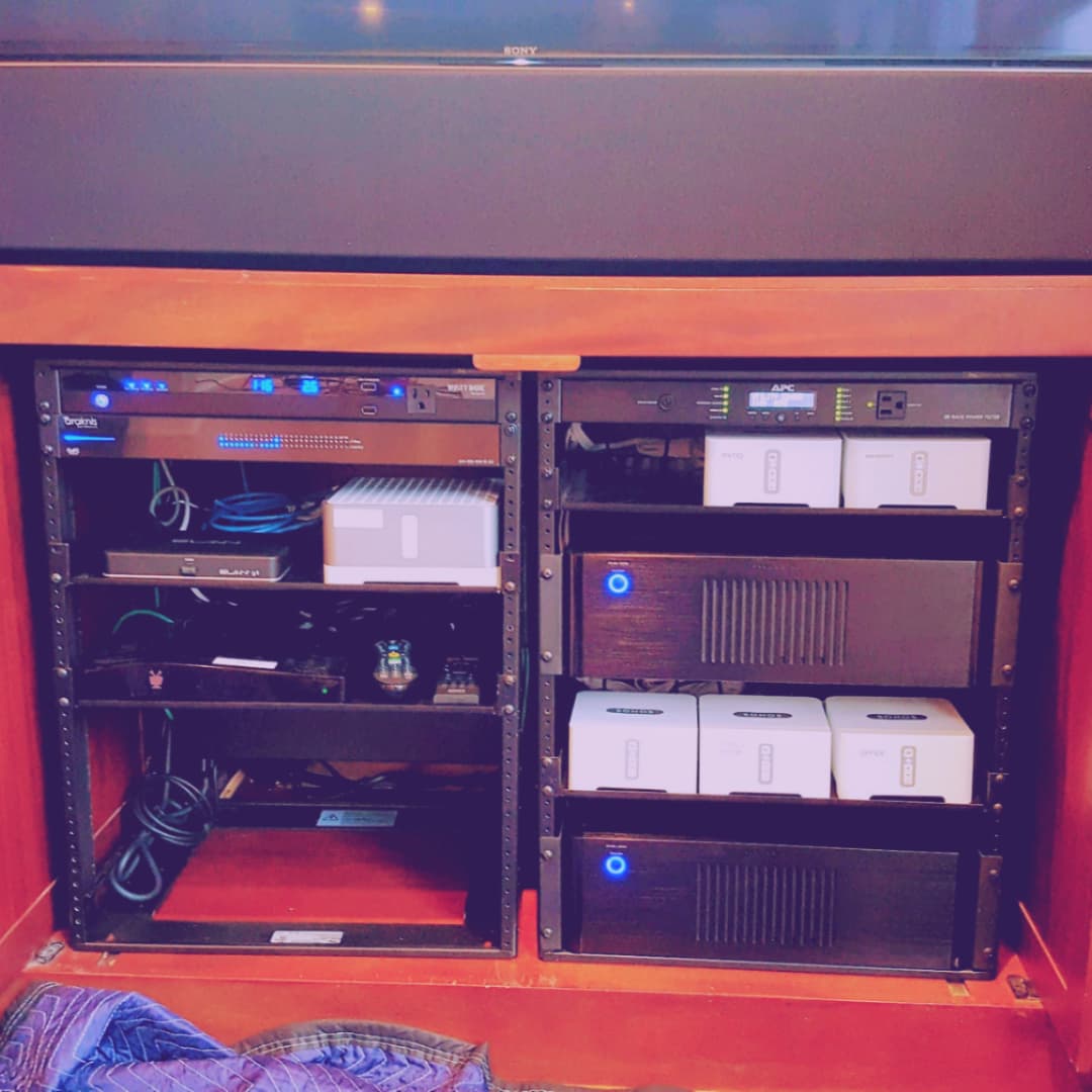 Hidden AV rack with organized equipment and cable paths