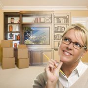 female holding pencil in room with drawing of entertainment unit