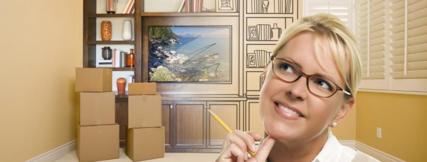 female holding pencil in room with drawing of entertainment unit